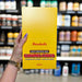 Close-up of (Barebells Soft Protein Bar 12x55g) held up inside My Supplement Shop, clearly showing the front label in a Sports Nutrition setting.